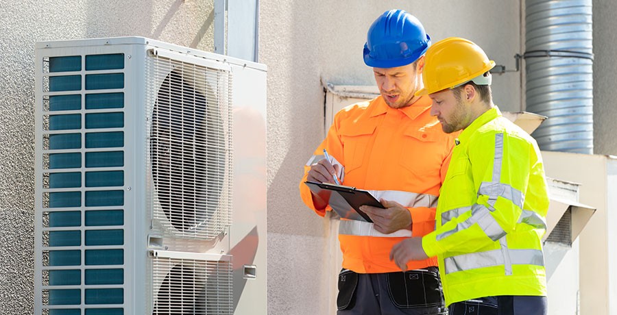 commercial electricians looking at clipboard