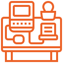 Orange icon of a workspace with a computer, laptop, desk, mouse, and person sitting.